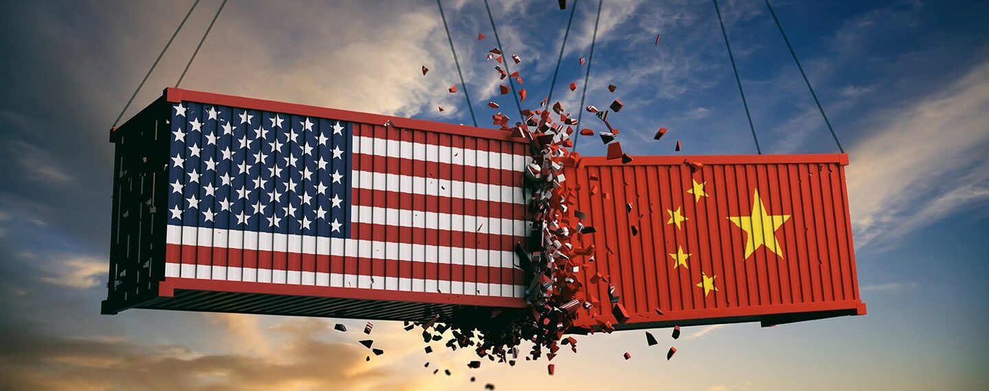 US of America and Chinese flags crashed containers on sky at sunset background